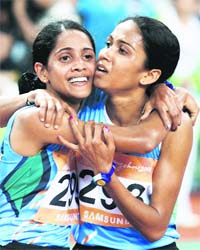 Indias Preeja Sreedharan (L) celebrates winning the womens 10,000-m final with compatriot Kavita Raut, who won silver