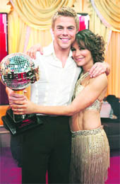 Professional dancer Derek Hough and his partner Jennifer Grey hold the coveted Mirror Ball trophy after being named champions of Dancing with the Stars during the finale.