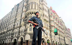 A commando stands guard in front of the Taj Mahal hotel on the eve of the second anniversary of the 26/11 attack in Mumbai on Thursday.