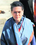 UPA chairperson Sonia Gandhi enters a temple in Barkhandi village during the first day of her three-day visit to Rae Bareli 
