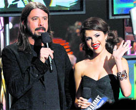 Musician Dave Grohl and actor Selena Gomez announce the nominees for Song Of The Year during The Grammy Nominations Concert Live — Countdown to the Music's Biggest Night event in Los Angeles on Wednesday.