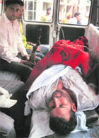 Mohammad Abbas, injured member of Vijay Topi gang, whose several members are proclaimed offenders, being taken to a hospital in Kharar on Friday.