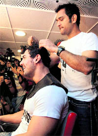 Bollywood actor John Abraham and cricketer M S Dhoni during an event in Mumbai on Saturday.