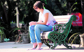 A visitor enjoys her own company in the sunny Sunday afternoon at Sector 17.
