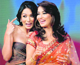 Bollywood actors Madhuri Dixit and Malaika Arora Khan (L) pose for a photograph during a promotional event on the sets of a TV reality show in Mumbai on Tuesday night.