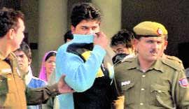 Police take one of the accused of the Sultanpuri rape case to a court in Rohini in New Delhi on Sunday.