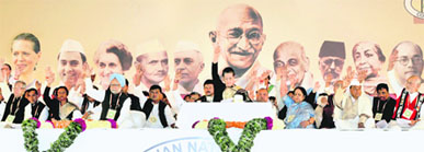 Cong president Sonia Gandhi (C), PM Manmohan Singh (L) and other senior leaders raise their hands in support of a resolution during the party’s 83rd plenary session in New Delhi on Sunday. 