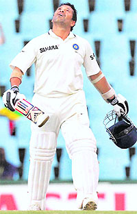 Sachin Tendulkar looks up as he celebrates his 50th Test century. Tendulkar bisected cover and extra cover field with an effortless drive off fast bowler Dale Steyn, ran a single and raised his arms in celebration.