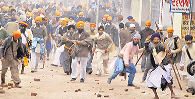 Sikh hardliners pelt stones on policemen after they were told to disperse following tension with Dera Sacha Sauda followers at Bhikhi in Mansa district on Sunday.