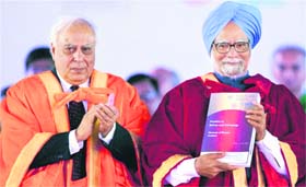 PM Manmohan Singh releases a publication as HRD Minister Kapil Sibal applauds at the 98th Indian Science Congress in Chennai