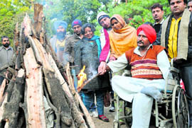 Singer Bant Singh lights up a bonfire to mark Lohri at the Chandigarh Press Club