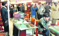 Police and forensic officials examine the showroom in Manimajra on Wednesday. Also seen is security guard Swaran Singh (on the chair)