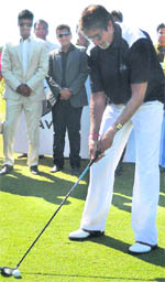 Bollywood megastar Amitabh Bachchan plays a shot to inaugurate the Gujarat Golf Challenge 2011 tournament in Ahmedabad recently