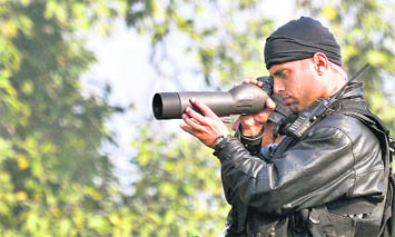 A Black Cat commando keeps vigil during the full dress rehearsal for Republic Day at Rajpath in New Delhi on Sunday.