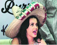 Singer Katy Perry wears a Mexican sombrero, a gift from a fan, during an autograph-signing event as part of promotional activities for her new fragrance Purr in Mexico City.