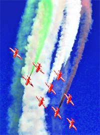 IAFs Suryakiran acrobatic team performs during the Aero India at Yelahanka air base in Bangalore