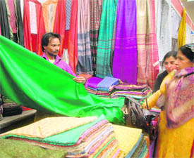 women take a look at the dress material.