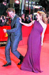 Actor Gerard Butler jokes with actress Jessica Chastain as they arrive for the screening of the movie Coriolanus during the 61st Berlinale film festival in Berlin.