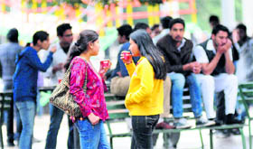 Students have a cup of hot coffee on a rainy day at the Panjab University.