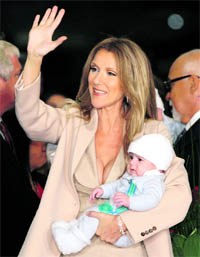 Celine Dion holds her son Nelson as she waves at her fans after arriving at Caesars Palace with her husband and sons in Las Vegas, Nevada. The singer begins a new series of shows in Las Vegas on March 15.