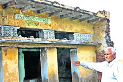 Dhanpat Singh Yadav, the then sarpanch of Chhillar, points at the ruins of a gurdwara in the village.