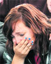 A girl cries for her mother, who is still trapped in the rubble of a building that collapsed in Christchurch on Tuesday.