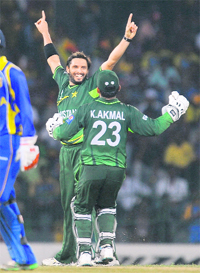 Pakistan captain Shahid Afridi celebrates with Kamran Akmal after dismissing Sri Lankan captain Kumar Sangakkara during their Group A match at the Premadasa Stadium in Colombo on Saturday. Afridi came up with a superb bowling performance (4-34) as Pakistan beat Lanka by 11 runs. 