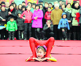 A young acrobat performs during the Shehuo festival to celebrate the Lantern Festival in Taiyuan, Shanxi province.