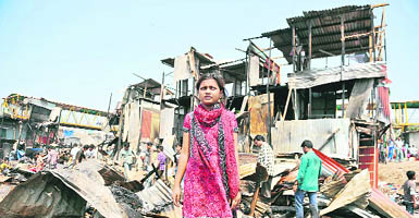 Rubina Ali of Slumdog Millionaire fame in front of her gutted house in Bandra, Mumbai, on Saturday. Not only her home, but her Oscar citation was also destroyed.