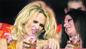 Pamela Anderson (L) during a carnival parade at the Sambadrome in Rio de Janeiro, Brazil, on Sunday.