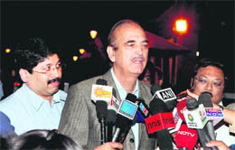 Ghulam Nabi Azad speaks to the media as MK Alagiri looks on in New Delhi.