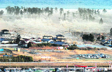 A massive tsunami sweeps in to engulf a residential area in Natori, Miyagi Prefecture in northeastern Japan, after a powerful earthquake hit the country on Friday.