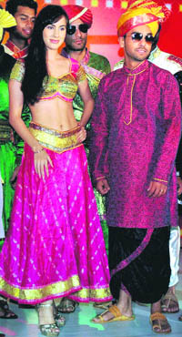 Canadian cricketers walk the ramp with a model during a fashion show in Mumbai on Friday night.