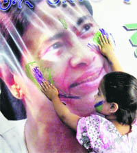 A girl colours a poster of Mamata Banerjee in West Bengal.