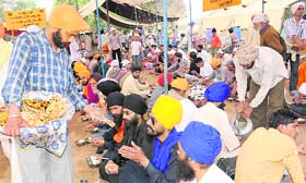 Devotees partake langar at Anandpur Sahib