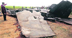 Libyans gather around the wreckage of a US F-15 fighter jet in Ghot Sultan, southeast of Benghazi, on Tuesday.