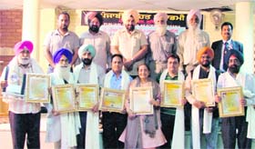 The eight writers who were honoured by the Lok Likhari Sabha, Jagraon, at Punjabi Bhawan in Ludhiana