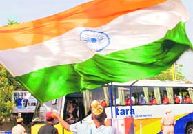 A cricket fan welcomes the Indian cricket team with the Tricolour outside the PCA Stadium in Mohali