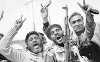Libyan rebels celebrate at a checkpoint in Al-Egila, near Ras Lanuf, on Sunday. The rebels claim they have entered Ras Lanuf.  AP/PTI
