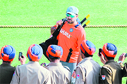 Security personnel take photos of cricketer Yuvraj Singh at the PCA Stadium in Mohali on Monday.