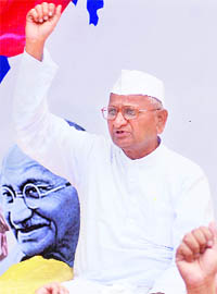 Social activist Anna Hazare gestures as he sits on fast-unto-death against corruption near Parliament in New Delhi.