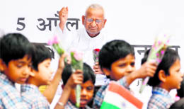Schoolchildren greet Anna Hazare with flowers at Jantar Mantar in New Delhi on Thursday.
