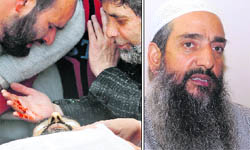 Mourners gather around the body of Showkat Ahmad Shah (right) in Srinagar on Friday.