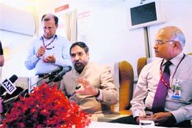 Commerce Minister Anand Sharma and NSA Shiv Shankar Menon address the media aboard Prime Minister's special flight to Sanya (China) on Tuesday