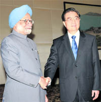 Prime Minister Manmohan Singh shakes hands with China's President Hu Jintao during a bilateral meeting on the sidelines of BRICS summit at Sanya, China, on Wednesday