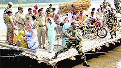 Paramilitary soldiers use a boat to reach a remote polling booth in Malda on Sunday.