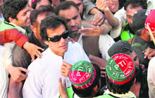 Cricketer-turned-politician Imran Khan with supporters at a rally against US drone strikes. 