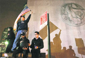 People gather to celebrate the death of Osama bin Laden at Ground Zero in New York on Monday.
