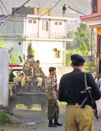 After Operation Geronimo: Pakistan soldiers outside the mansion where Al-Qaida chief Osama bin Laden was killed in a secret operation by US special forces