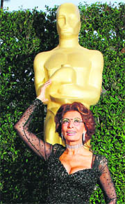Italian actress Sophia Loren poses with a large Oscar statue prior to the Academy of Motion Picture Arts & Sciences Tribute to Sophia Loren in Beverly Hills, California.